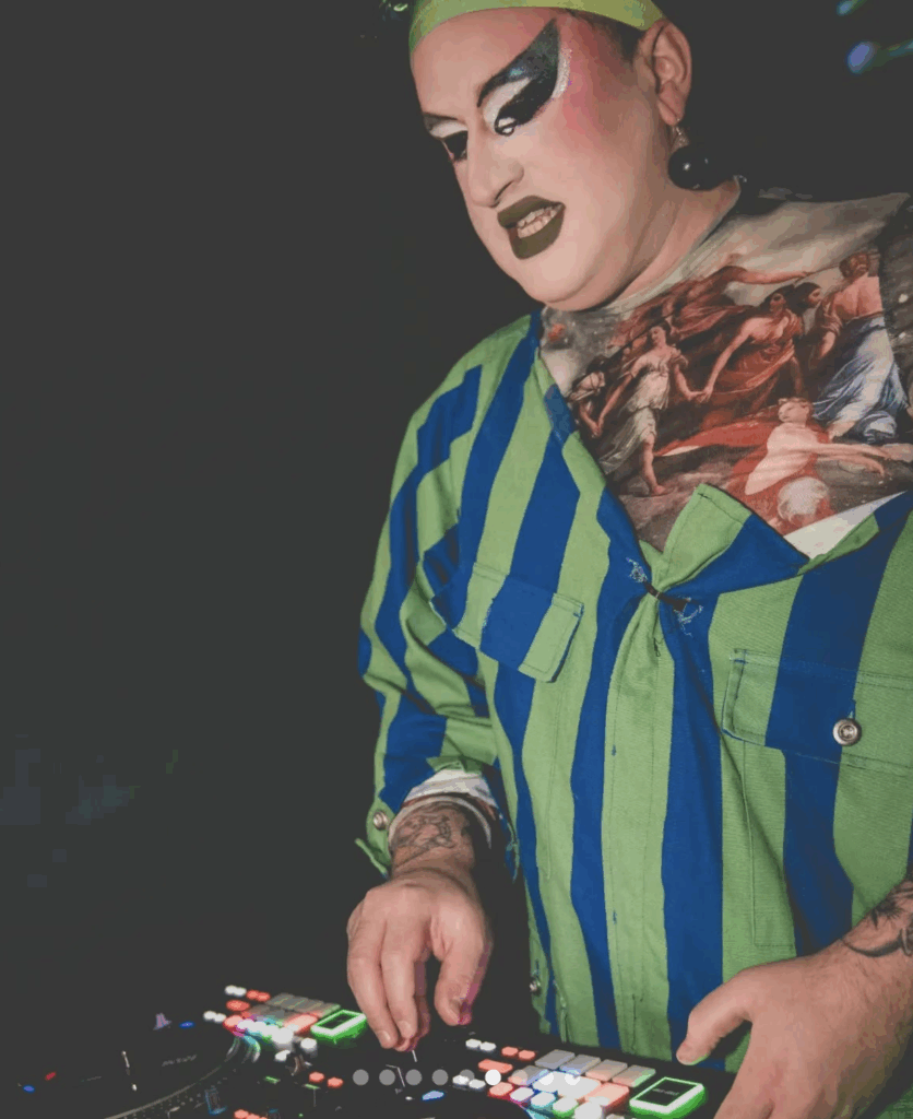Boston Drag Queen and Queer DJ Coleslaw mixing at a dance party